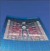  ?? Streeter Lecka Getty Images ?? THE NCAA men’s basketball tournament bracket is displayed on the J.W. Marriott hotel in Indianapol­is.