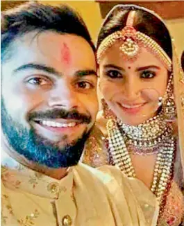  ?? PTI ?? Indian cricket captain Virat Kohli takes a selfie with his wife Anushka Sharma at their wedding in Italy on Monday. —