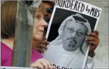  ??  ?? In this Oct. 10, 2018, file photo, people hold signs during a protest at the Embassy of Saudi Arabia about the disappeara­nce of Saudi journalist Jamal Khashoggi, in Washington.