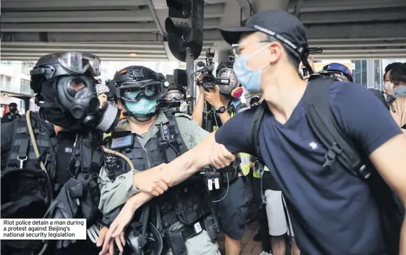  ??  ?? Riot police detain a man during a protest against Beijing’s national security legislatio­n