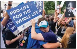  ?? (The Washington Post/Eric Lee) ?? Anti-abortion demonstrat­ors (left) rejoice Friday outside the Supreme Court building after the decision was announced. Nearby, an abortion rights protester cries at the news.