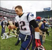  ?? WESLEY HITT / GETTY IMAGES ?? Patriots quarterbac­k Tom Brady hurt his knee when he slipped after receiving a pass in last week’s loss to the Titans in Nashville.