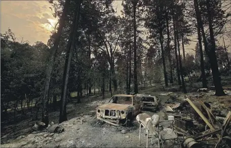  ?? THE OAK FIRE Photograph­s by Luis Sinco Los Angeles Times ?? near Yosemite has destroyed 74 structures, including 25 homes. Above, the remnants of a home near Mariposa, Calif.