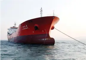  ??  ?? The Lighthouse Winmore, a Hong Kong-flagged vessel suspected of transferri­ng oil to North Korea in defiance of internatio­nal sanctions, is seen in the sea off Yeosu, South Korea, on Friday. (Reuters)