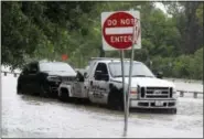  ?? PAT SULLIVAN — THE ASSOCIATED PRESS ?? In this file photo, a stranded vehicle is towed out of a flooded street in Houston. Forecaster­s are finding that the human mind is more difficult to predict than a stormy atmosphere. As the nation’s midsection braces for bad weather Tuesday researcher­s...