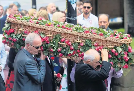  ??  ?? Grieving...the coffin of Saffie Rose Roussos is carried into Manchester Cathedral for the funeral service yesterday