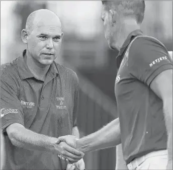  ?? AP PHOTO ?? In this Aug. 17, 2017, file photo, Bill Haas, left, shakes hands with Henrik Stenson after the first round of the Wyndham Championsh­ip golf tournament in Greensboro, N.C.