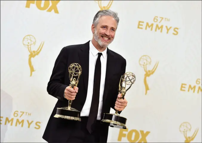  ?? JORDAN STRAUSS / INVISION / AP FILE (2015) ?? Jon Stewart holds the awards for outstandin­g writing for a variety series and outstandin­g variety talk show for “The Daily Show with Jon Stewart,” on Sept. 20, 2015, at the 67th Primetime Emmy Awards in Los Angeles.