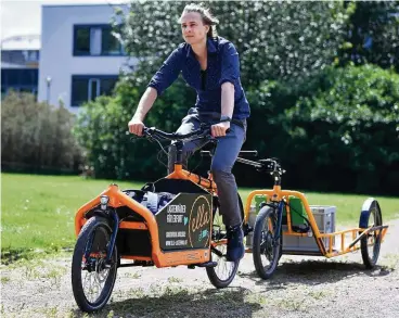  ?? FOTO: MARTIN SCHUTT/DPA ?? Tobias Hage von der Erfurter Lastenrad-initiative „Ella“fährt mit einem Lastenrad mit Anhänger durch den Erfurter Beethovenp­ark.