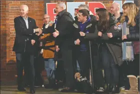  ?? (AP/Elise Amendola) ?? Former Vice President Joe Biden greets supporters Saturday while arriving for an event in Manchester, N.H., as he struggles to regroup from his fourth-place showing in Iowa.