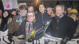  ?? CP PHOTO ?? Quebec Premier Philippe Couillard, Quebec City mayor Regis Labeaume, Prime Minister Justin Trudeau and NDP Leader Thomas Mulcair lead a march during a vigil Monday, January 30, 2017 in Quebec City. A shooting at a Quebec City mosque left six people...
