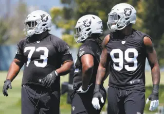  ?? Paul Chinn / The Chronicle ?? Maurice Hurst ( 73), P. J. Hall and Arden Key ( 99) run through a defensive drill during a minicamp for first- year players at the Raiders’ practice facility in Alameda in May.