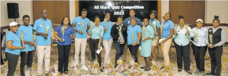  ?? ?? Members of the winning and second-place teams in the Sandals Montego Bay All Star Quiz Competitio­n proudly pose with their trophies.