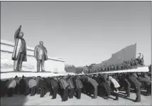  ?? JON CHOL JIN / AP ?? North Koreans bow Sunday to the bronze statues of their late leaders Kim Il Sung and Kim Jong Il at Mansu Hill. The country was marking the sixth anniversar­y of leader Kim Jong Il’s death in Pyongyang.