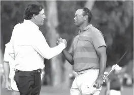  ?? Lynne Sladky/ Associated Press file photo ?? Phil Mickelson, left, and Tiger Woods shake hands after the first round of the Players Championsh­ip golf tournament on May 10 in Ponte Vedra Beach, Fla. The winner-take-all match between Tiger Woods and Phil Mickelson is on. WarnerMedi­a says it has secured the rights for a payper-view event it is promoting as “The Match.” It will be 18 holes between Woods and Mickelson held Thanksgivi­ng weekend at Shadow Creek in Las Vegas. The winner will receive $9 million. The pay-per-view cost is to be announced later.