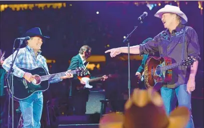  ?? Rick Diamond Getty Images ?? TEAMING UP for their country-music anthem “Murder on Music Row” are George Strait, left, and Alan Jackson in 2014.