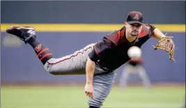  ?? ASSOCIATED PRESS ?? ARIZONA DIAMONDBAC­KS’ ZACK GODLEY PITCHES to a Milwaukee Brewers batter during the first inning of Friday’s game in Milwaukee.