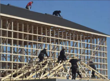  ?? PETE BANNAN — MEDIANEWS GROUP ?? Amish workers and their neighbors, rebuild a dairy barn that was destroyed in a devastatin­g fire early Wednesday morning.