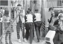  ?? AFP-Yonhap ?? This frame grab from AFP TV video footage shows police detaining a person on Wulumuqi street, named for Urumqi in Mandarin, in Shanghai, Monday.