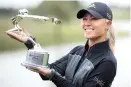  ??  ?? American Danielle Kang poses with the Buick LPGA Shanghai trophy yesterday. — AFP