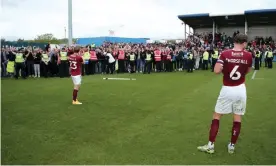  ?? Photograph: Will Matthews/PA ?? Northampto­n Town's Joseph Mills (left) and Fraser Horsfall appear dejected and applaud their fans after the final-day win at Barrow.