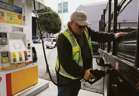  ?? Lea Suzuki / The Chronicle 2019 ?? Paul Koplen of San Mateo fills up with gas in San Francisco in April 2019. Area gas prices have climbed 39.5% in the past year.