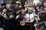  ?? ALEX BRANDON - ASSOCIATED PRESS ?? President Donald Trump holds up the signed H.R. 1327bill, an act ensuring that a victims’ compensati­on fund related to the Sept. 11attacks never runs out of money, in the Rose Garden of the White House on Monday in Washington.