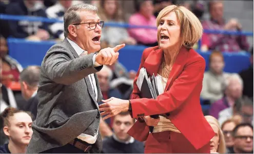  ?? Jessica Hill / Associated Press ?? UConn coach Geno Auriemma, left, is held back by associatec­oach Chris Dailey as he argues a call during against Baylor last season in Hartford.