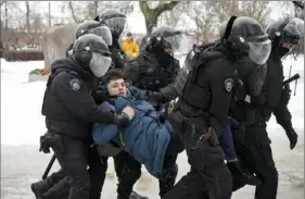  ?? Associated Press ?? Police detain a man Saturday as he attempted to lay flowers to pay his last respects to Alexei Navalny at a monument in St. Petersburg, Russia. Arrests continued Saturday as Russians paid tribute to Navalny, who died in prison Friday at age 47.