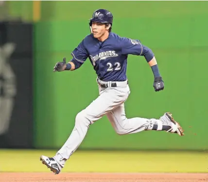  ?? GETTY IMAGES ?? Christian Yelich runs to second base after hitting a double in the first inning Tuesday night in Miami.