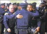  ?? Louis DeLuca / Associated Press ?? Dallas Police officers console each other at funeral of Rogelio Santander.