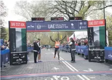  ?? Photos Jennifer S Altman for The National ?? Top, Some of the 8,000 participan­ts snake their way through Central Park in New York in the UAE Healthy Kidney 10K Run; Above, Rhonex Kipruto of Kenya took 27 seconds off the record to win the race also known as the Zayed Charity Marathon; left, some...