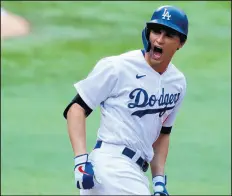  ?? CURTIS COMPTON/TNS ?? Corey Seager celebrates his solo home run against the Atlanta Braves in Game 6 on Saturday.