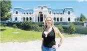  ?? CHARLES KING/ORLANDO SENTINEL ?? In this archived photo, Jackie Siegel stands in front her house, known as ‘Versailles’, that has been under constructi­on for about 15 years.