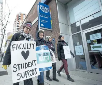  ?? NATHAN DENETTE/THE CANADIAN PRESS ?? Teachers and faculty staff of the Ontario Public Service Employees Union walk the picket line at George Brown College in Toronto on Nov. 16. An arbitrator appointed to settle a contract dispute with Ontario college faculty after a fiveweek strike...