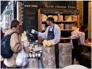  ??  ?? Buying cheese at Borough Market in London