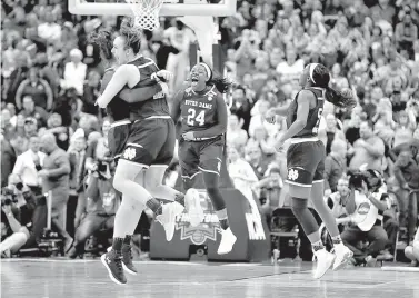  ?? AP Photo/Ron Schwane ?? ■ Notre Dame’s Arike Ogunbowale (24) celebrates with teammates after making a 3-point basket to defeat Mississipp­i State, 61-58, in the final of the women’s NCAA Final Four on Sunday in Columbus, Ohio.