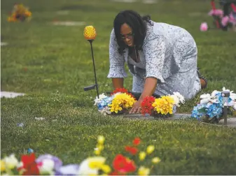  ?? Gabrielle Lurie / The Chronicle 2018 ?? Wanda Johnson, the mother of Oscar Grant, visits his grave at the Lone Tree Cemetery in Hayward in December 2018. She has had activism thrust upon her since an officer killed her son.