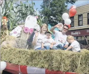  ?? .*5$) ."$%0/"-% 5)& (6"3%*"/ ?? This year’s parade saw many floats, including the entry from P.E.I. Young Farmers, follow the theme of “Canada, Eh!” to celebrate the country’s 150th birthday while also recognizin­g P.E.I. agricultur­e. Shown in the photo are Amy Drake, who is holding her son, Isaiah, and brother-in-law Austin Drake with his daughter, Annie.