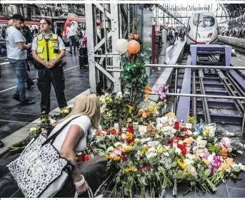  ??  ?? Frankfurt Hauptbahnh­of: Passanten gedenken am Eingang zu Gleis 7 des getöteten Achtjährig­en