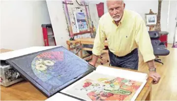  ?? — AFP ?? Steve Meadows, an architect, actor, inventor and dabbler in art, poses in his Venice, California, home with two paintings he shipped to the Van Gogh Museum in Amsterdam for an authentica­tion review as possible works by the Dutch master artist.