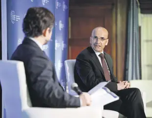  ?? ?? Treasury and Finance Minister Mehmet Şimşek (R) delivers a speech at the “Global Outlook Forum” organized by the Institute of Internatio­nal Finance (IIF), Washington, U.S., April 17, 2024.