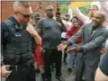  ?? STEVE MELLON/PITTSBURGH POST-GAZETTE VIA AP ?? Leonard Hammonds II, of Penn Hills, right, points out that a Turtle Creek Police officer has his hand on his weapon during a rally in East Pittsburgh, Pa., on Wednesday, at a protest regarding the shooting death of Antwon Rose by an East Pittsburgh...