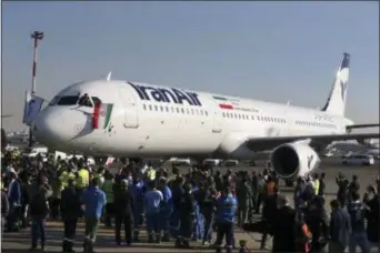  ?? VAHID SALEMI — THE ASSOCIATED PRESS FILE ?? In this file photo, the pilot of Iran Air’s new Airbus plane waves a national flag after landing at Mehrabad Internatio­nal Airport in Tehran, Iran.