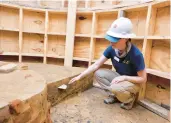  ?? ?? From left: A livestream camera is recording excavation of a well in Historic Jamestowne. Archaeolog­ist Natalie Reid examines part of the well under excavation. A fragment of a Delftware drug jar found during excavation of the well.