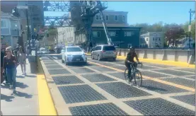  ?? STEVE FAGIN ?? Jennifer Lacker rides her gravel bike across the Mystic River bridge.