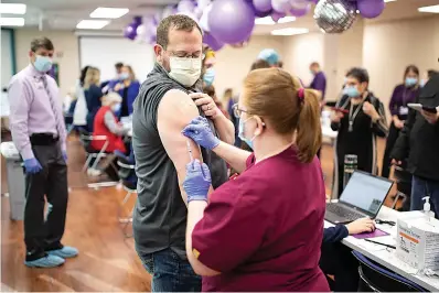  ?? Staff photo by Kelsi Brinkmeyer ?? ■ Dr. Jason Harris, Medical Director of the Emergency Department at Christus St. Michaels, was among the first in Texarkana to receive the COVID-19 vaccine. The hospital received the shipment of vaccines Thursday, and offered it to their frontline workers that afternoon.