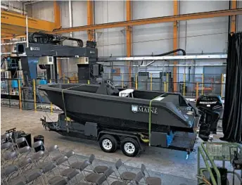  ?? RON LISNET/UNIVERSITY OF MAINE ?? A polymer 3D printer created the 25-foot, 5,000-pound boat, which was unveiled Wednesday in Orono, Maine.