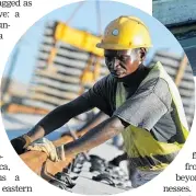  ??  ?? A worker helps build the MombasaNai­robi Railway.