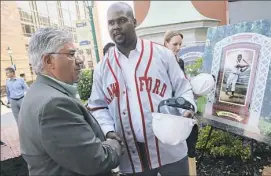  ?? Lake Fong/Post-Gazette ?? State Sen. Wayne Fontana, left, greets Sean Gibson, great-grandson of Negro League legend Josh Gibson, after the Josh Gibson Heritage Park groundbrea­king Wednesday at Station Square.